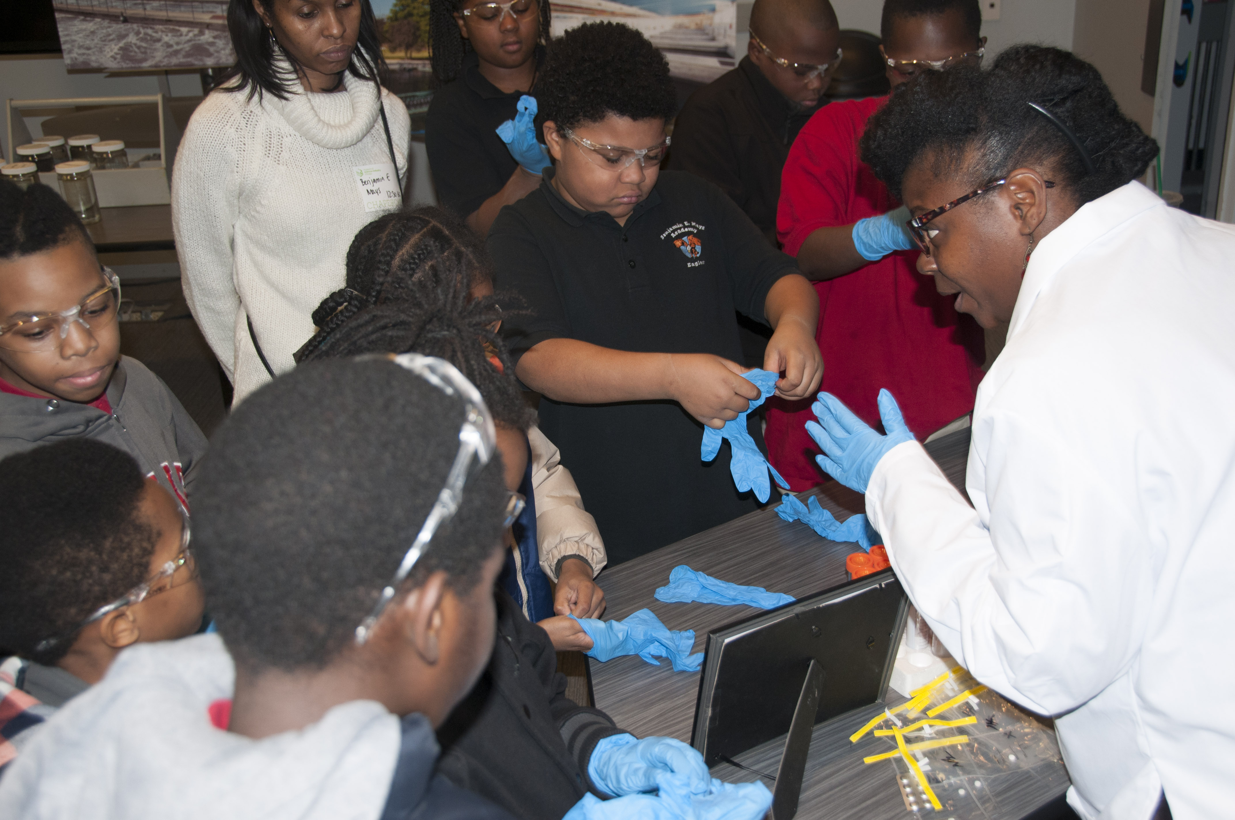 Tiffany Poole, Assistant Environmental Chemist, leads students through a hands-on practicum to test water samples for pH, dissolved oxygen, ammonia and nitrate levels in 2016 at the Museum of Science and Industry.